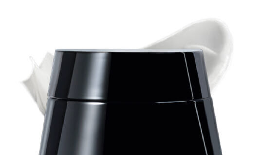 Contenitore nero con una parte superiore bianca, simile a una crema o un prodotto cosmetico.