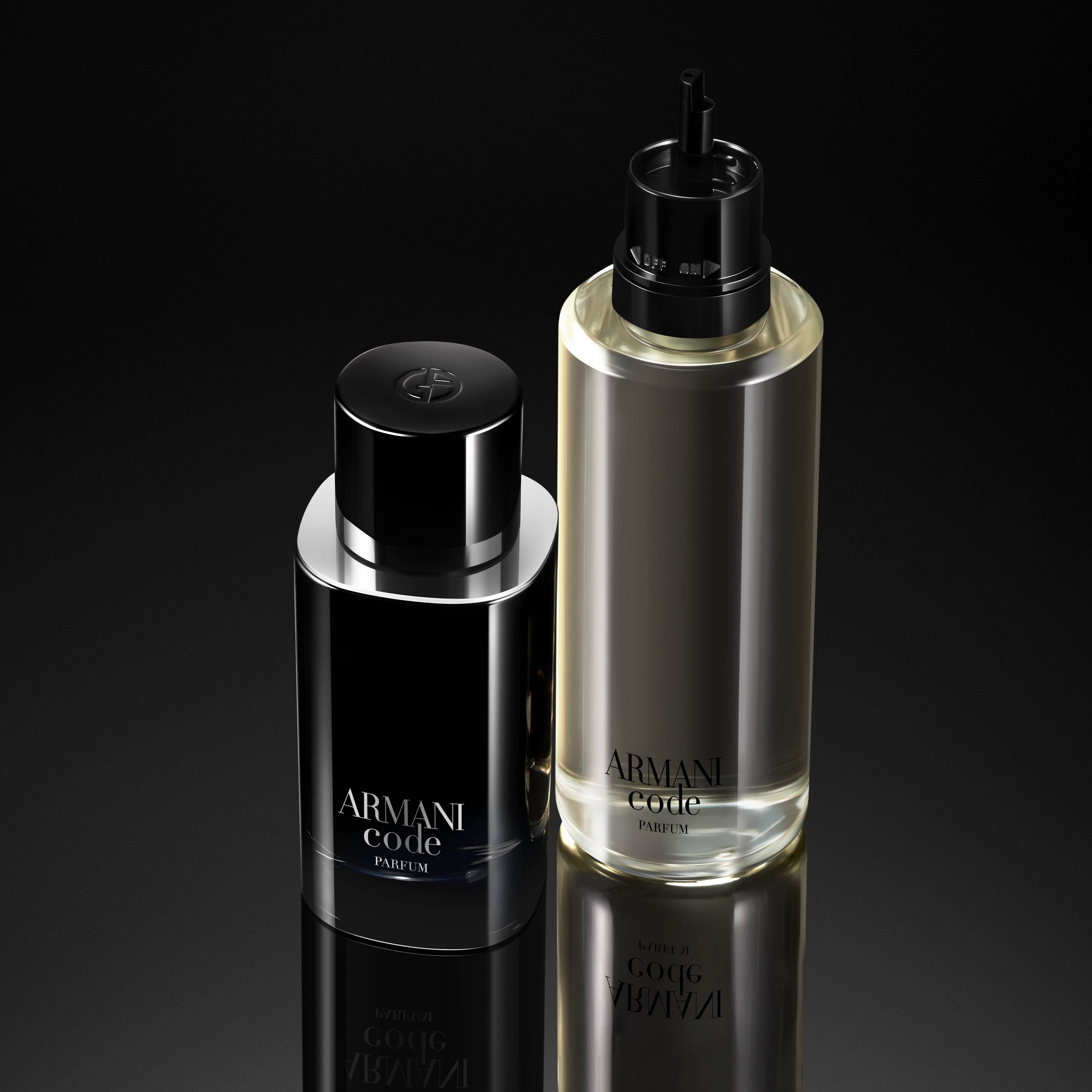 Two Armani Code perfume bottles side by side on a reflective black surface. The left bottle is sleek and black, while the right bottle is a transparent glass with a silver cap.