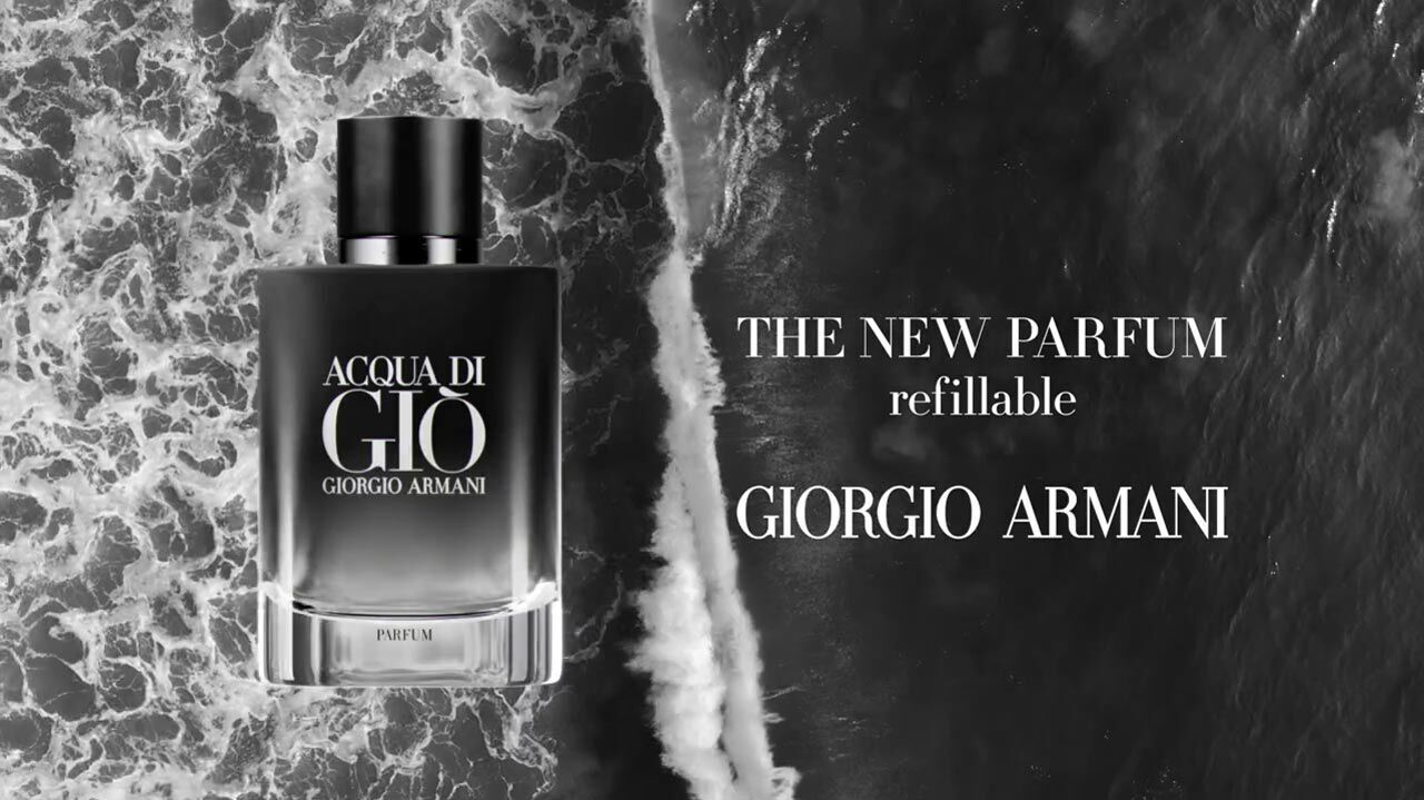 A black and white image of a Giorgio Armani Acqua di Gio refillable perfume bottle, displayed over a background of ocean waves.