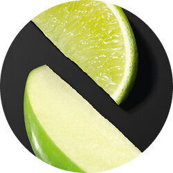 Close-up of Bergamot and green apple slices on a black background, representing fresh notes in Armani fragrance.
